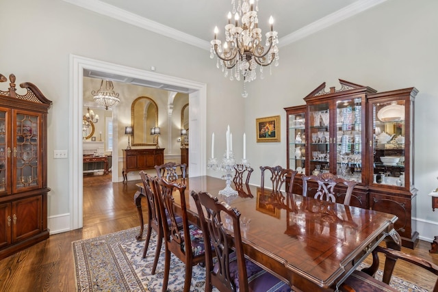 224 3rd Ave S, Franklin, TN 37064 - dining area with baseboards, a chandelier, crown molding, and dark wood-type flooring