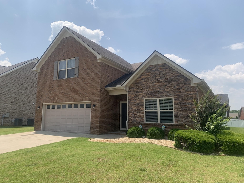 5115 Heroes Ln, Murfreesboro, TN 37129 - view of front of house with an attached garage, a front lawn, driveway, central air condition unit, and stone siding