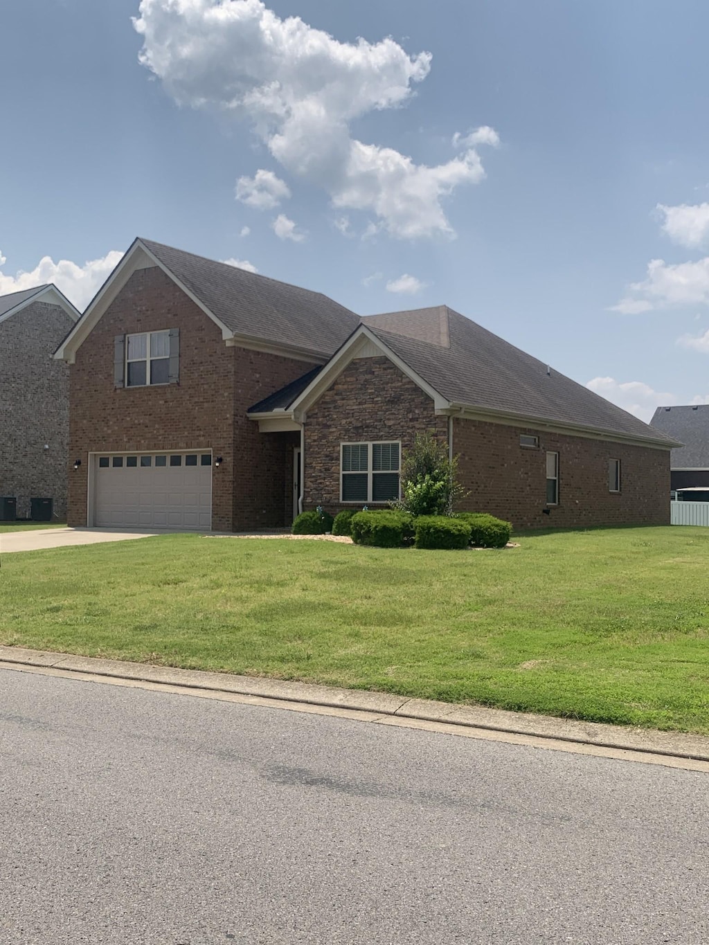 5115 Heroes Ln, Murfreesboro, TN 37129 - view of front facade featuring a garage, concrete driveway, a front lawn, and brick siding
