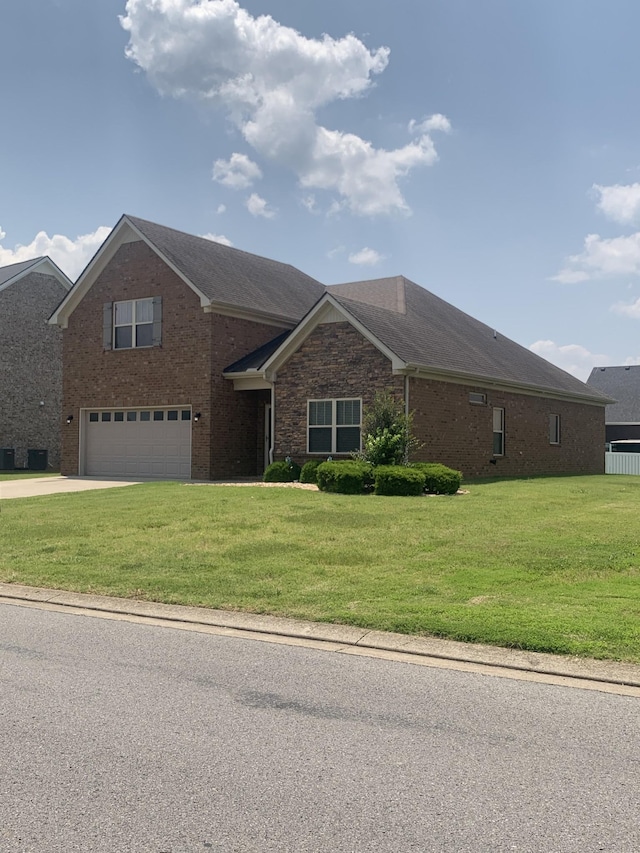 5115 Heroes Ln, Murfreesboro, TN 37129 - view of front facade featuring a garage, concrete driveway, a front lawn, and brick siding