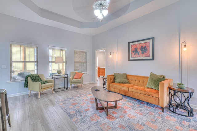 5115 Heroes Ln, Murfreesboro, TN 37129 - living area with light wood-style floors, a ceiling fan, baseboards, and a tray ceiling