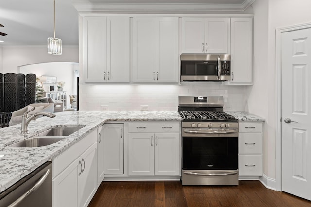 6061 Starboard Ln, Franklin, TN 37064 - kitchen with stainless steel appliances, a sink, crown molding, white cabinets, and dark wood-style floors