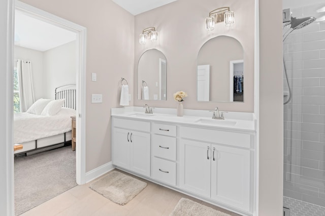 6061 Starboard Ln, Franklin, TN 37064 - ensuite bathroom featuring double vanity, tiled shower, tile patterned flooring, and baseboards