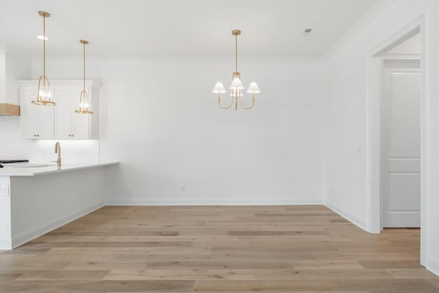 3150 Long Branch Cir, Franklin, TN 37064 - unfurnished dining area featuring a chandelier, ornamental molding, light wood-type flooring, and baseboards