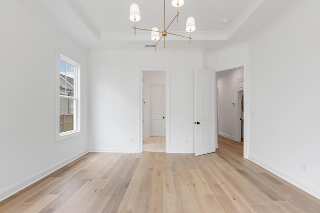 3150 Long Branch Cir, Franklin, TN 37064 - empty room featuring a raised ceiling, a chandelier, light wood-type flooring, baseboards, and ornamental molding