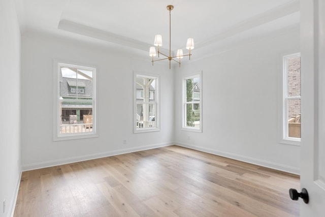 3150 Long Branch Cir, Franklin, TN 37064 - spare room with a chandelier, light wood-style flooring, a tray ceiling, and baseboards