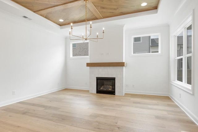 3150 Long Branch Cir, Franklin, TN 37064 - unfurnished living room featuring a chandelier, light wood finished floors, a tiled fireplace, recessed lighting, and a raised ceiling