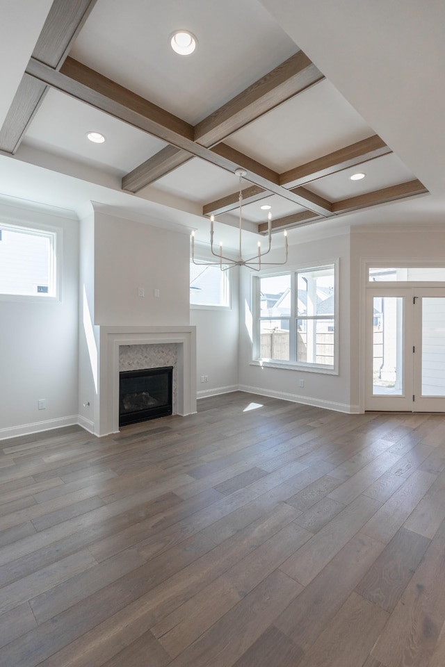 3168 Long Branch Cir, Franklin, TN 37064 - unfurnished living room with coffered ceiling, baseboards, a chandelier, beamed ceiling, and a glass covered fireplace