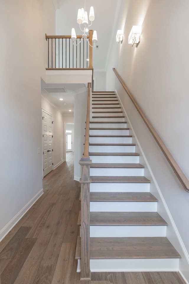 3168 Long Branch Cir, Franklin, TN 37064 - stairs featuring a high ceiling, wood finished floors, a chandelier, baseboards, and crown molding