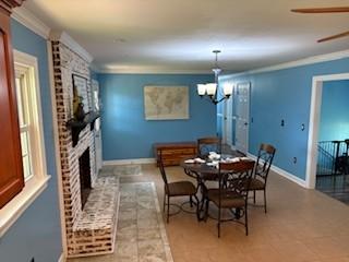 1704 Deer Hollow Dr W, Lawrenceburg, TN 38464 - dining area featuring a chandelier, a fireplace, ceiling fan, and ornamental molding