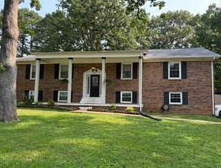 1704 Deer Hollow Dr W, Lawrenceburg, TN 38464 - split foyer home with a porch, a front yard, and brick siding