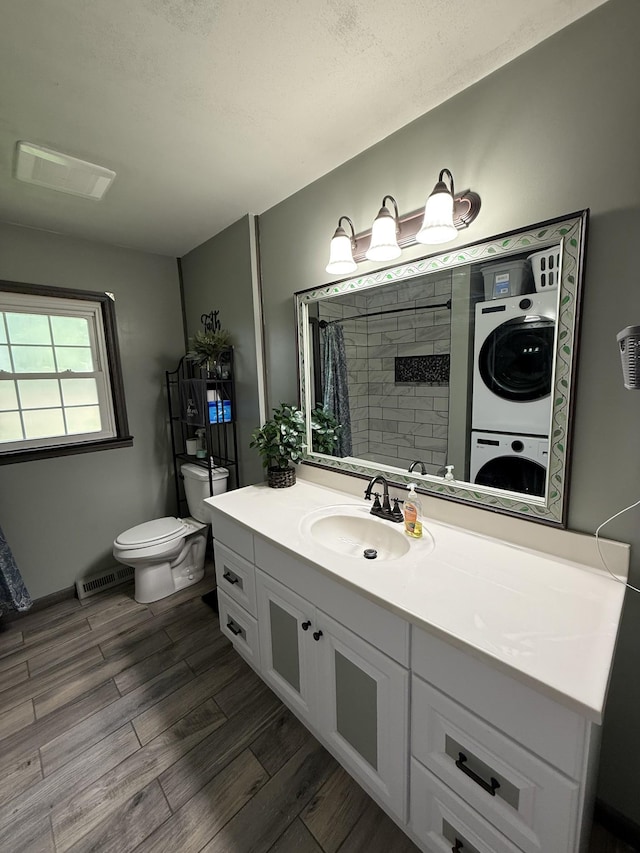 1704 Deer Hollow Dr W, Lawrenceburg, TN 38464 - bathroom with stacked washer and clothes dryer, wood finished floors, vanity, and tiled shower