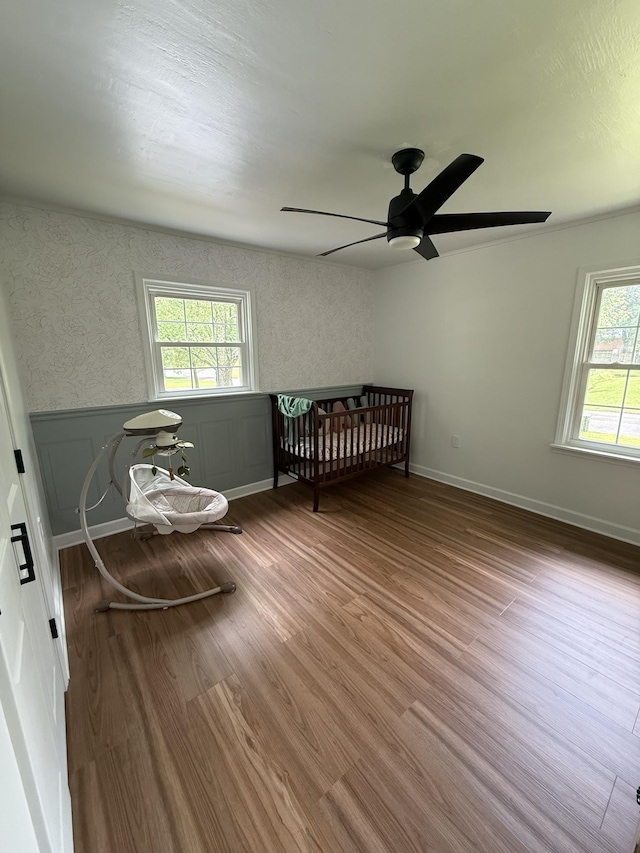 1704 Deer Hollow Dr W, Lawrenceburg, TN 38464 - bedroom featuring multiple windows, wood finished floors, a ceiling fan, and wainscoting