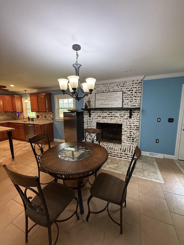 1704 Deer Hollow Dr W, Lawrenceburg, TN 38464 - dining room with crown molding, a chandelier, a brick fireplace, light tile patterned floors, and recessed lighting
