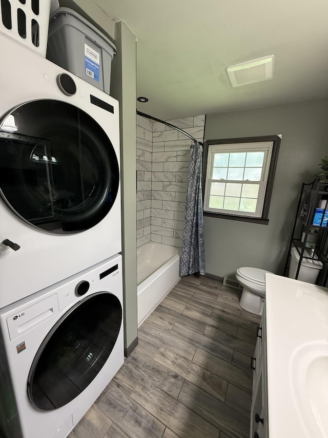 1704 Deer Hollow Dr W, Lawrenceburg, TN 38464 - bathroom with stacked washer / dryer, vanity, wood finished floors, and shower / bath combination with curtain