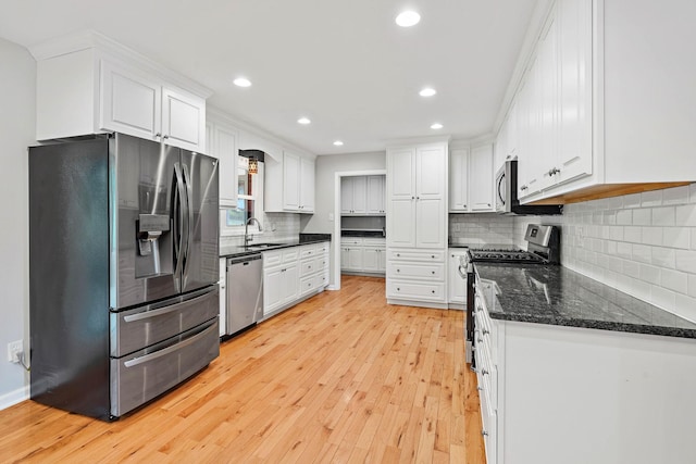 2952 Carters Creek Station Rd, Columbia, TN 38401 - kitchen featuring appliances with stainless steel finishes, white cabinetry, light wood-style floors, decorative backsplash, and recessed lighting