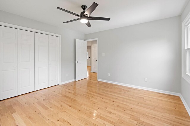 2952 Carters Creek Station Rd, Columbia, TN 38401 - unfurnished bedroom with light wood-style flooring, baseboards, a closet, and a ceiling fan