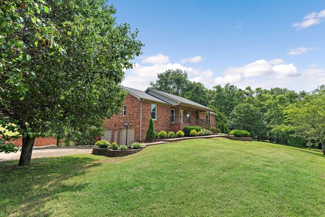2952 Carters Creek Station Rd, Columbia, TN 38401 - view of front of property featuring brick siding, an attached garage, concrete driveway, and a front lawn