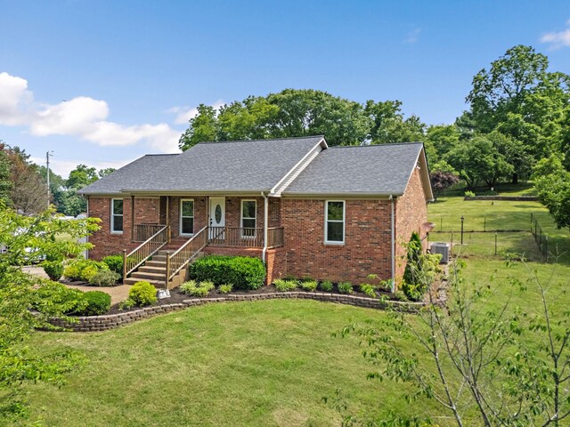 2952 Carters Creek Station Rd, Columbia, TN 38401 - ranch-style home with a porch, cooling unit, brick siding, and roof with shingles