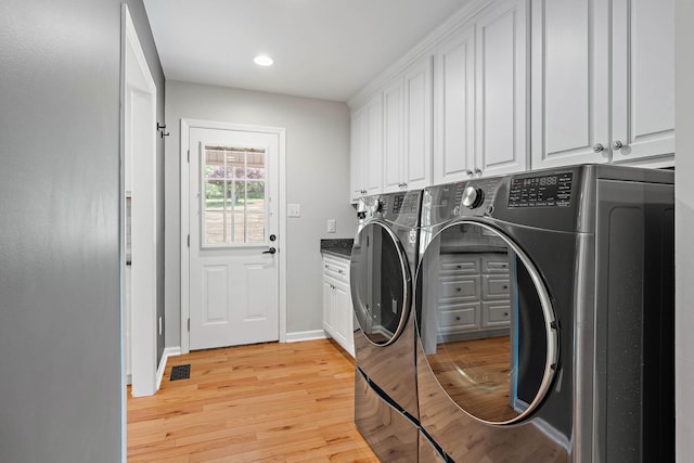 2952 Carters Creek Station Rd, Columbia, TN 38401 - laundry area featuring cabinet space, washing machine and dryer, light wood finished floors, recessed lighting, and baseboards