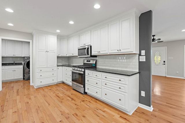 2952 Carters Creek Station Rd, Columbia, TN 38401 - kitchen featuring appliances with stainless steel finishes, tasteful backsplash, light wood-type flooring, white cabinetry, and recessed lighting