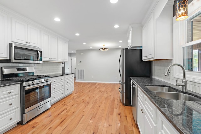 2952 Carters Creek Station Rd, Columbia, TN 38401 - kitchen featuring appliances with stainless steel finishes, a sink, white cabinetry, baseboards, and backsplash