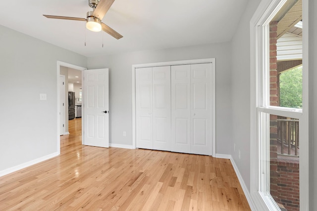 2952 Carters Creek Station Rd, Columbia, TN 38401 - unfurnished bedroom featuring light wood finished floors, baseboards, and a closet