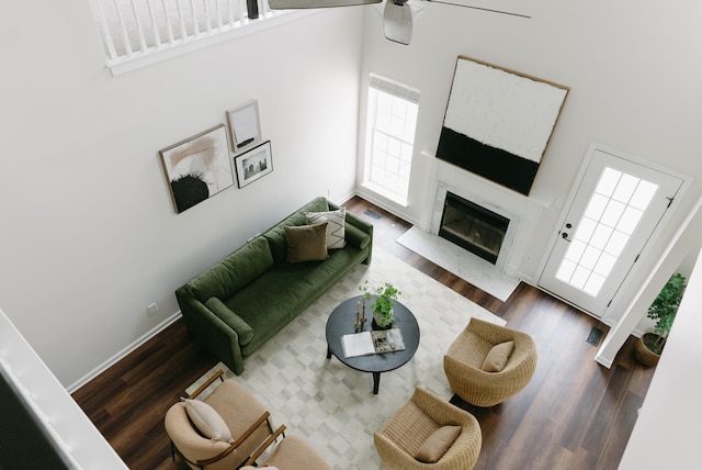 307 Fletcher Ct, Franklin, TN 37067 - living area featuring wood finished floors, ceiling fan, a fireplace, a high ceiling, and baseboards