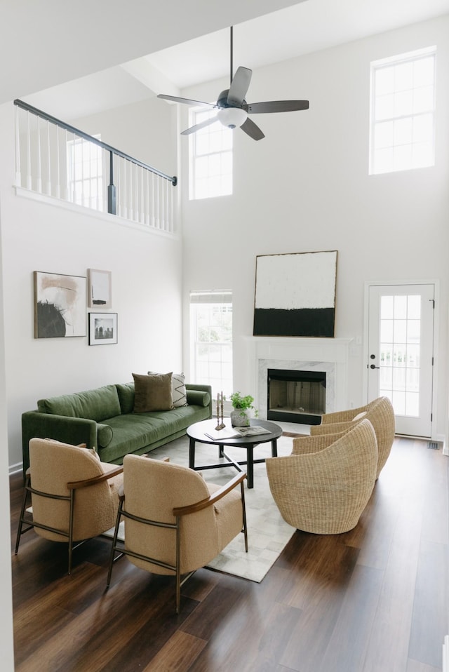 307 Fletcher Ct, Franklin, TN 37067 - living area featuring a high ceiling, a ceiling fan, a fireplace, and wood finished floors