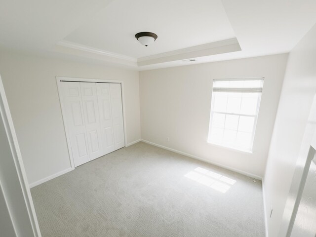307 Fletcher Ct, Franklin, TN 37067 - unfurnished bedroom featuring a raised ceiling, carpet, baseboards, and a closet