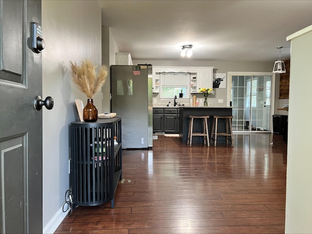 831 Harris Rd, Dickson, TN 37055 - kitchen with freestanding refrigerator, a sink, dark wood-type flooring, open shelves, and a breakfast bar