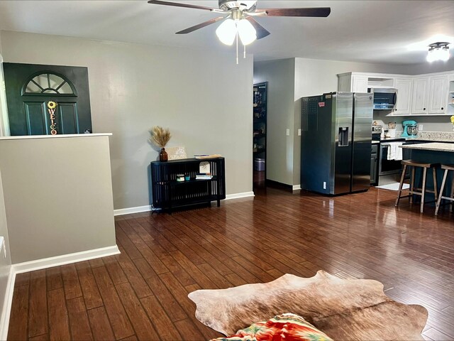 831 Harris Rd, Dickson, TN 37055 - living room featuring a ceiling fan, dark wood-style floors, and baseboards