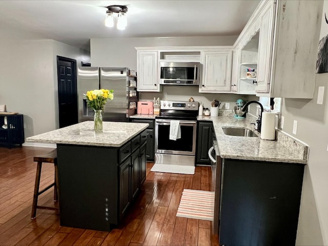 831 Harris Rd, Dickson, TN 37055 - kitchen with stainless steel appliances, a sink, white cabinetry, open shelves, and a kitchen breakfast bar