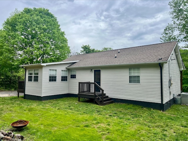 831 Harris Rd, Dickson, TN 37055 - back of property with a fire pit, a lawn, a shingled roof, and cooling unit
