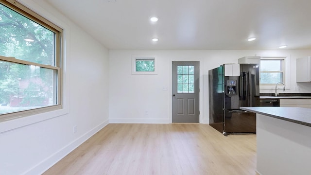 110 Lynn Ln, Old Hickory, TN 37138 - kitchen with black fridge, light wood-style flooring, white cabinets, a sink, and recessed lighting
