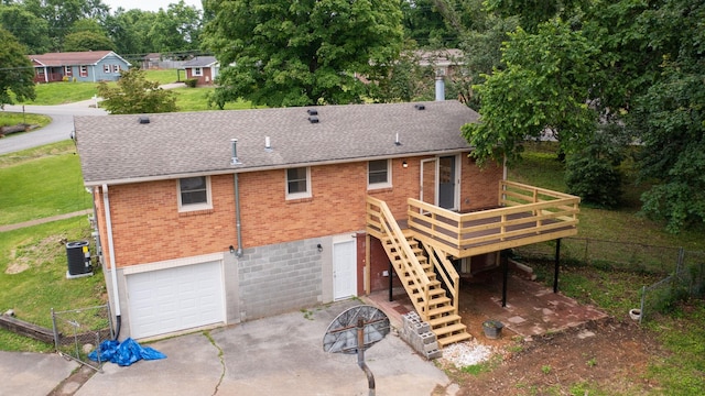 110 Lynn Ln, Old Hickory, TN 37138 - rear view of house with brick siding, a wooden deck, central AC, and roof with shingles