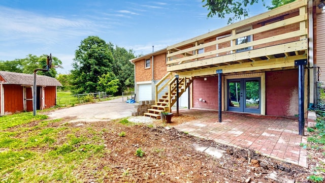 110 Lynn Ln, Old Hickory, TN 37138 - rear view of property featuring french doors, stairway, a wooden deck, and a garage