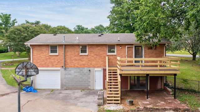 110 Lynn Ln, Old Hickory, TN 37138 - back of property with brick siding, a wooden deck, stairway, an attached garage, and driveway