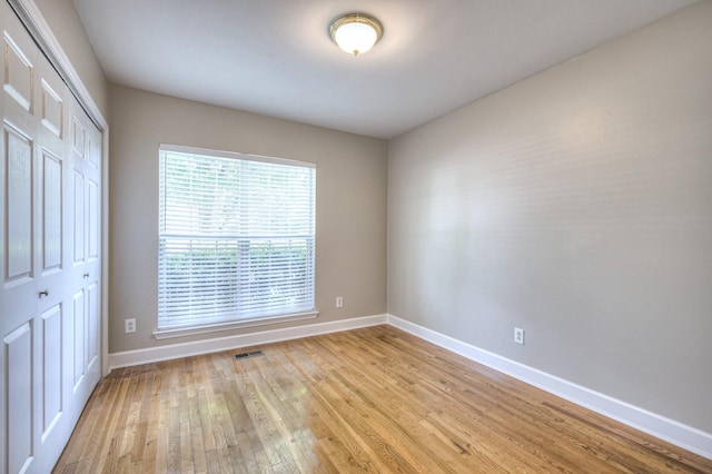 1030 Meandering Way, Franklin, TN 37067 - unfurnished bedroom with a closet, baseboards, and light wood-style floors