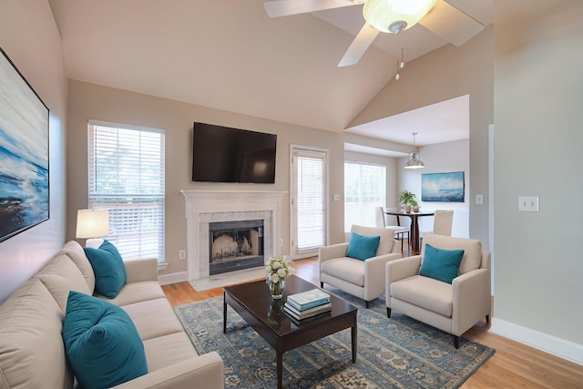 1030 Meandering Way, Franklin, TN 37067 - living room with light wood-style floors, plenty of natural light, vaulted ceiling, a fireplace, and a ceiling fan