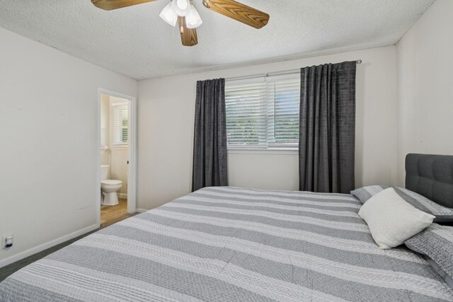 4904 Rainier Dr, Old Hickory, TN 37138 - carpeted bedroom with multiple windows, a textured ceiling, ensuite bathroom, baseboards, and a ceiling fan