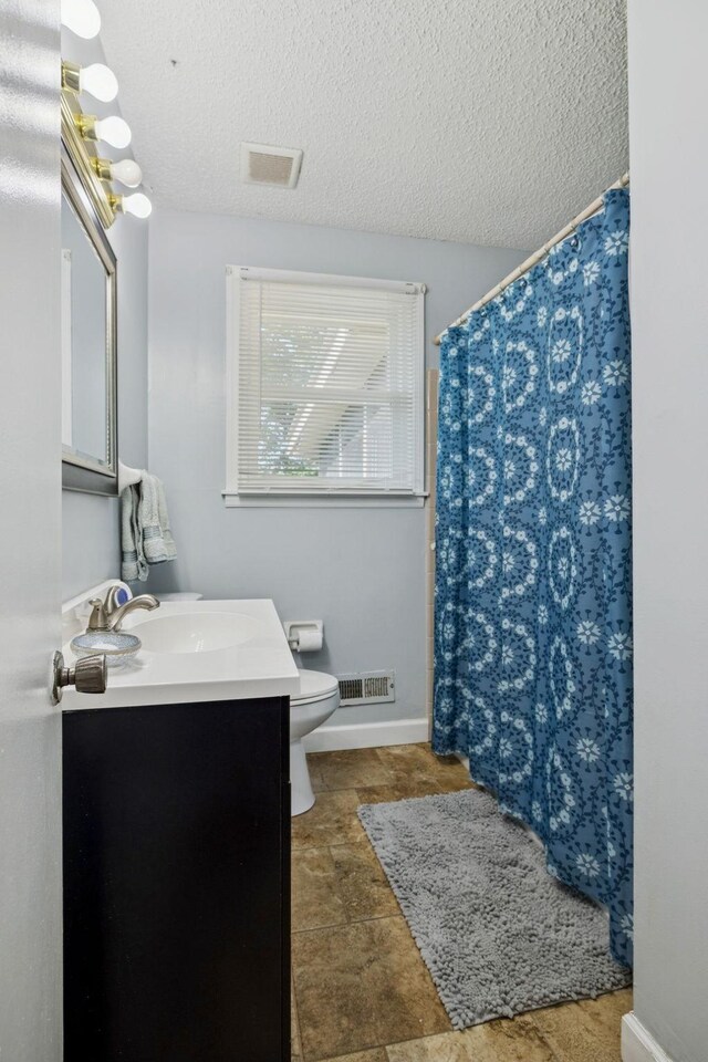4904 Rainier Dr, Old Hickory, TN 37138 - bathroom with vanity, toilet, a textured ceiling, and a shower with shower curtain