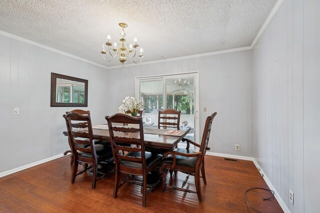 4904 Rainier Dr, Old Hickory, TN 37138 - dining space featuring a chandelier, wood finished floors, ornamental molding, a textured ceiling, and baseboards
