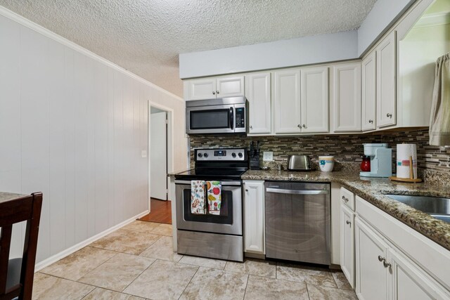 4904 Rainier Dr, Old Hickory, TN 37138 - kitchen with stainless steel appliances, crown molding, a textured ceiling, backsplash, and white cabinets