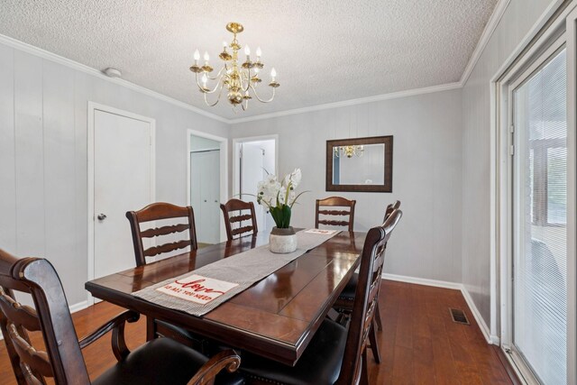 4904 Rainier Dr, Old Hickory, TN 37138 - dining area featuring dark wood-type flooring, a chandelier, a textured ceiling, crown molding, and baseboards
