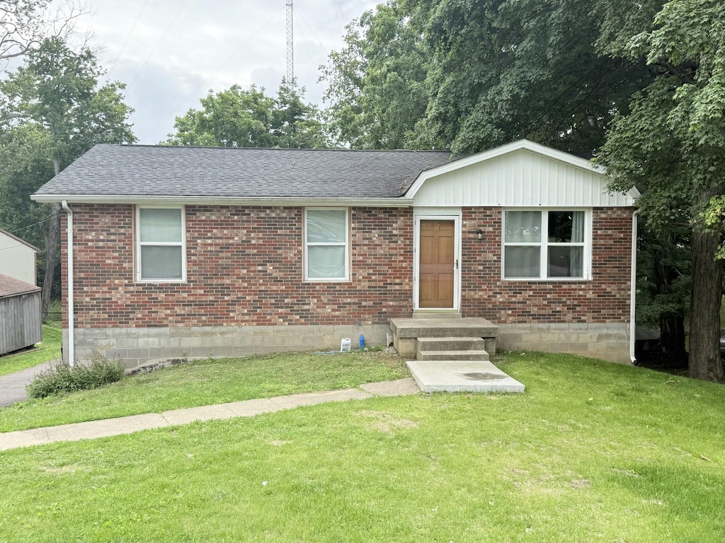 1308 Adrian Dr, Springfield, TN 37172 - view of front of house with brick siding, a front yard, and a shingled roof