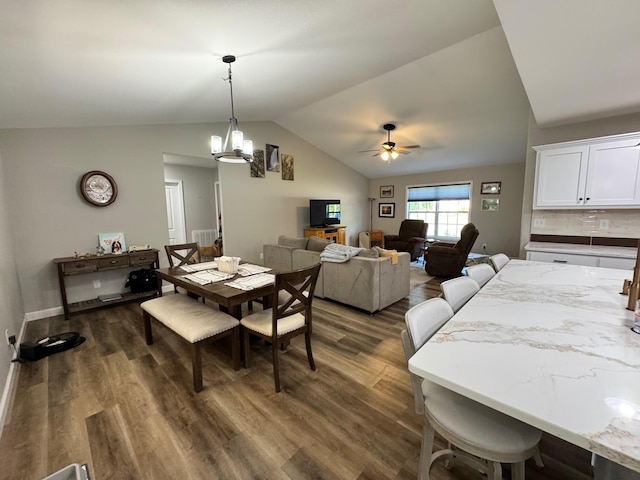 111 Stellar Ct, Clarkrange, TN 38553 - dining room with ceiling fan, vaulted ceiling, dark wood-style flooring, a chandelier, and baseboards