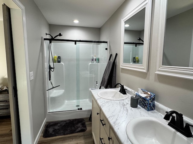 111 Stellar Ct, Clarkrange, TN 38553 - bathroom with wood finished floors, a shower stall, double vanity, and recessed lighting