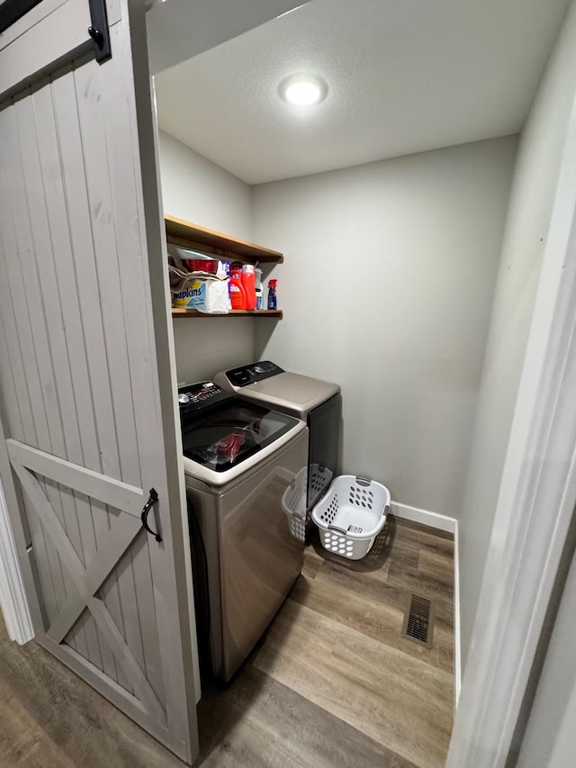 111 Stellar Ct, Clarkrange, TN 38553 - laundry room featuring washer and dryer, wood finished floors, and baseboards
