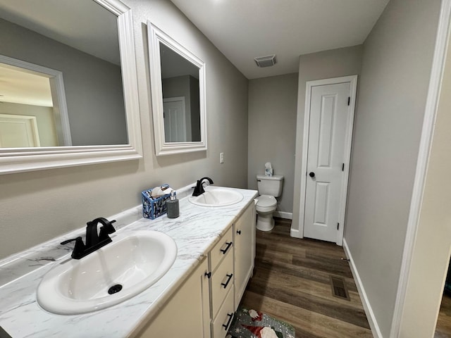 111 Stellar Ct, Clarkrange, TN 38553 - bathroom featuring toilet, double vanity, wood finished floors, and baseboards